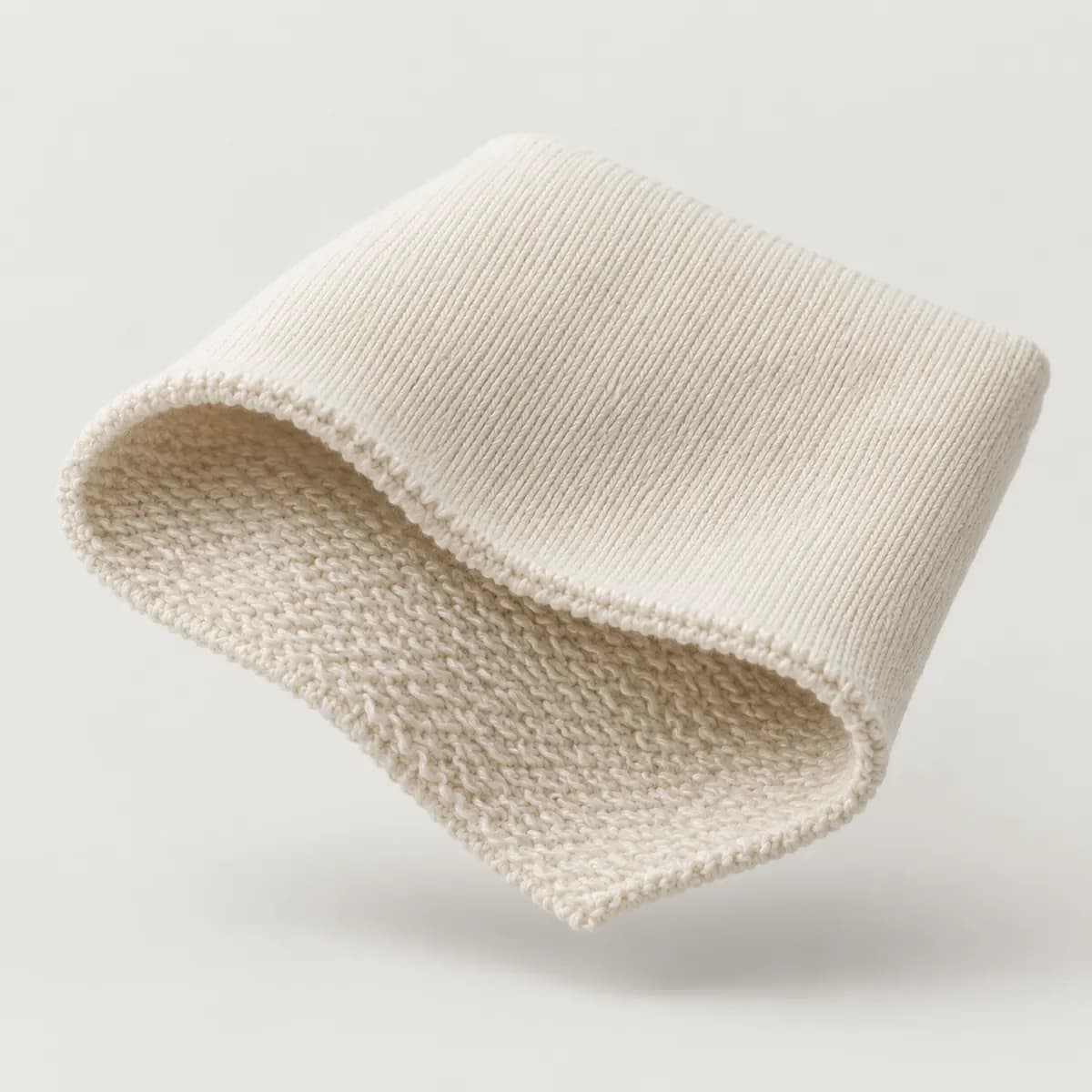 Cream french terry swatch folded to show the looped back