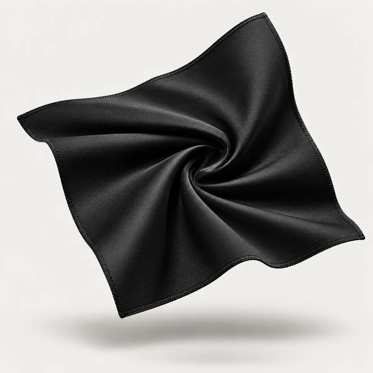 Black lycra fabric swatch twisted to show stretch and sheen